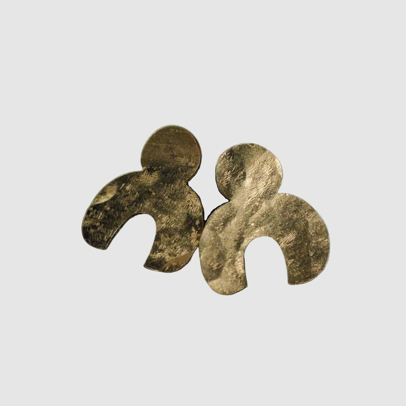 Hand hammered vermeil post earrings handmade by Tasha Bundy in Tucson, on a light grey background