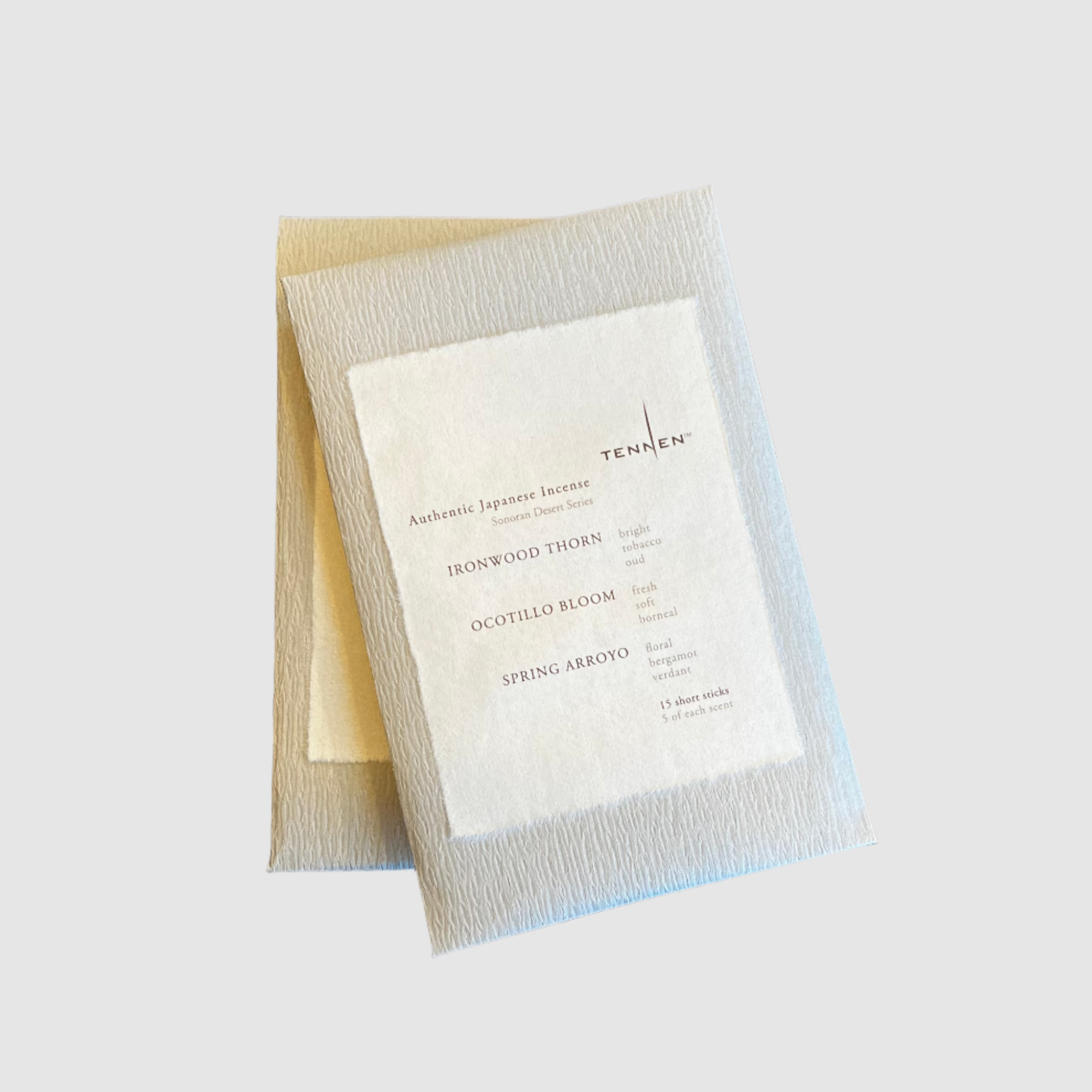 Two packets of the Tennen Sonoran Desert Mix Incense on a grey background.