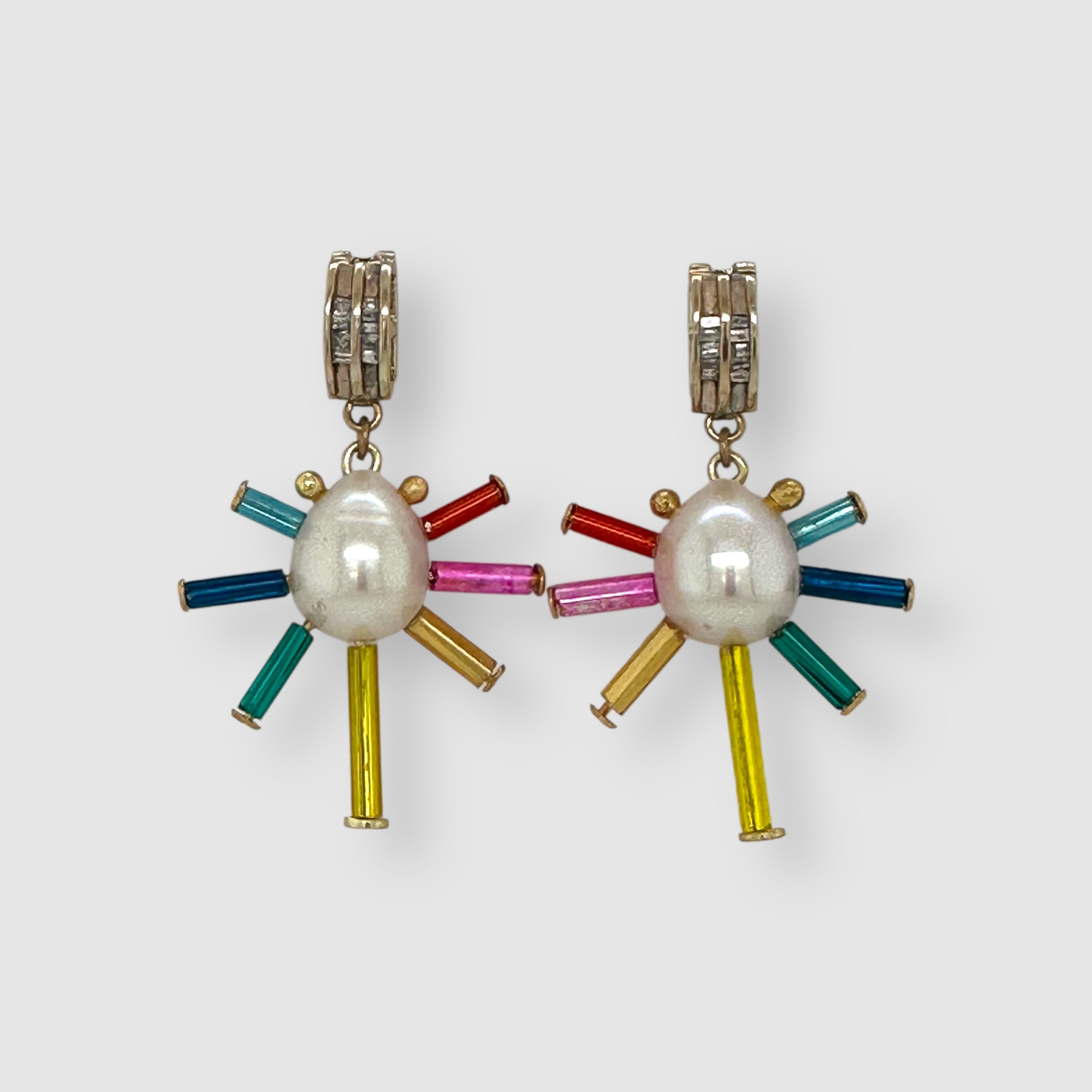 Pair of earrings handmade by Sofie Albertsen in Tucson, Arizona. Pearl center with vintage glass beads strung on a vintage diamond bracelet piece. Displayed on a light grey background.