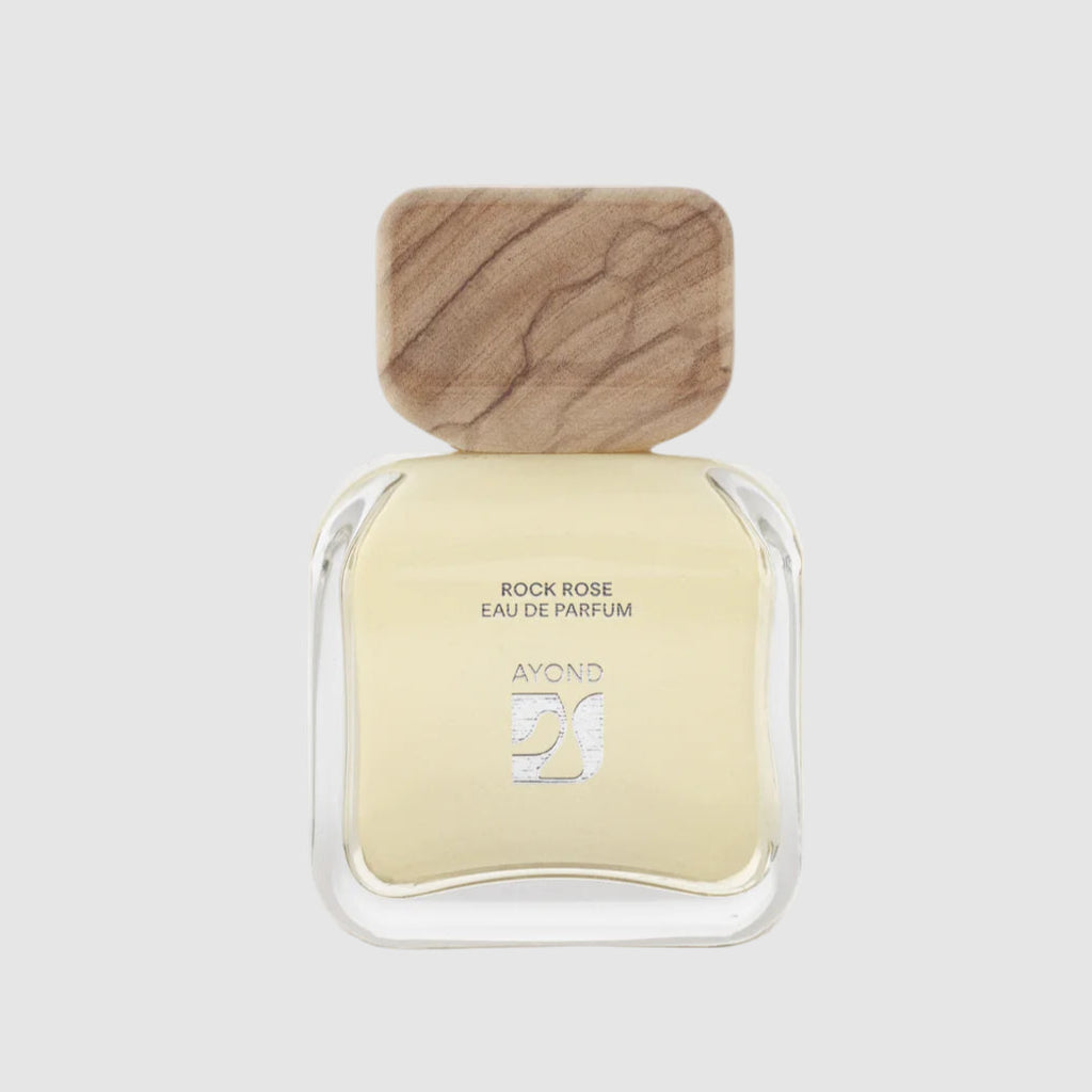Ayond "Rock Rose" perfume bottle with wooden cap on a light grey background