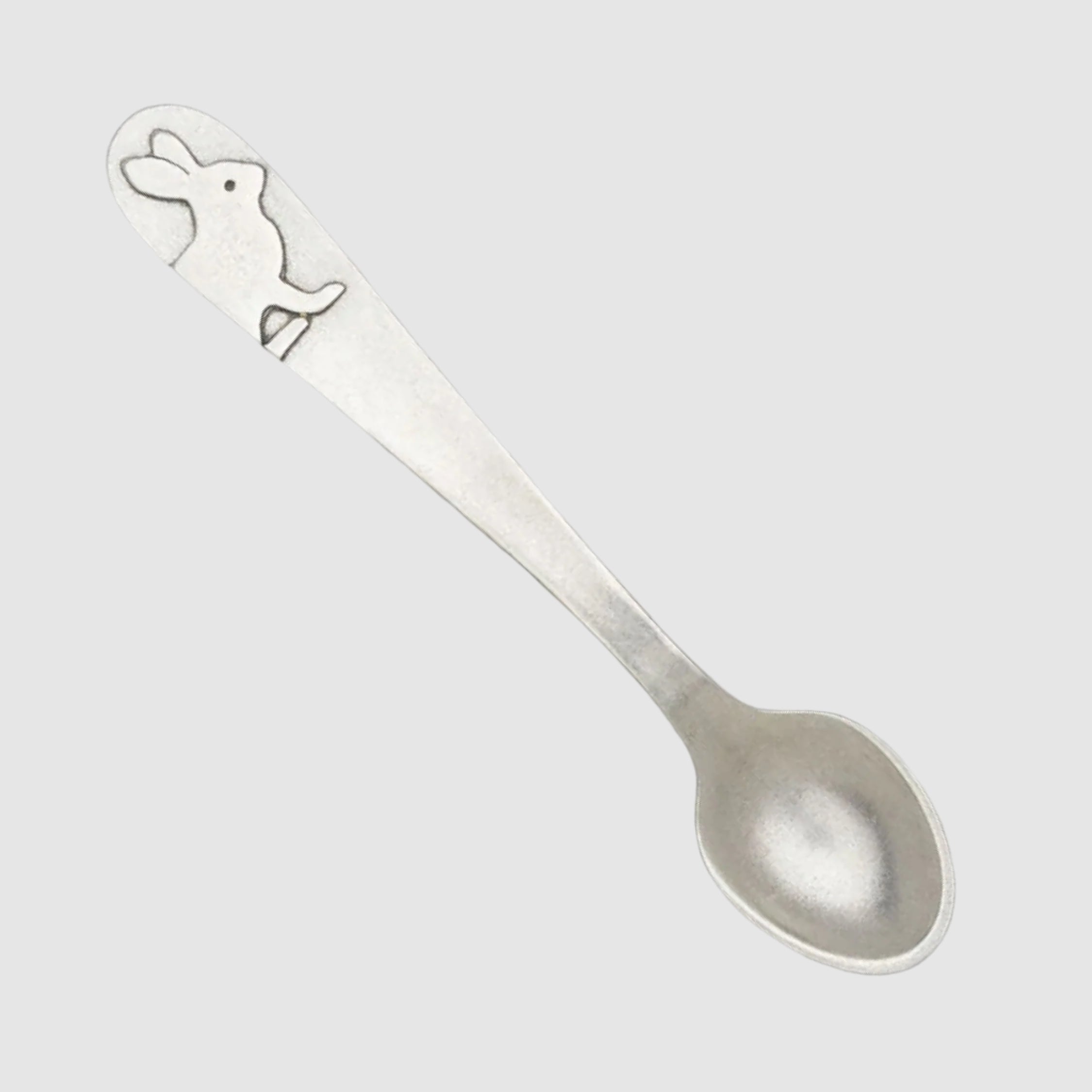 Silver spoon with a rabbit design on a white background