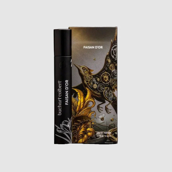 10mL Perfume bottle with 'buchartcolbert'  Faisan d'Or branded packaging featuring a phoenix made of gears on a light grey background