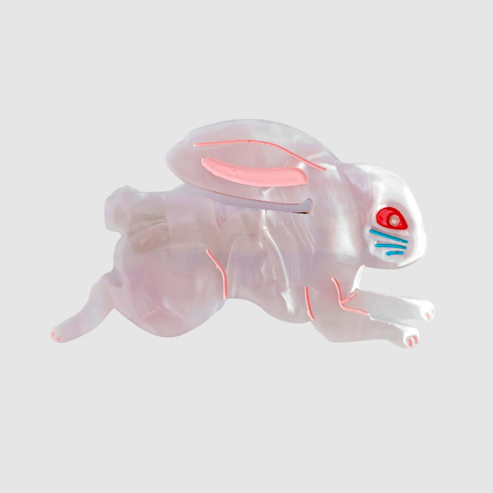 A pink, centinelle, ligonberry bunny barrette hair clip on a light grey background