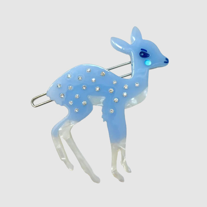 A blue, Centinelle, deer barrette on a light grey background