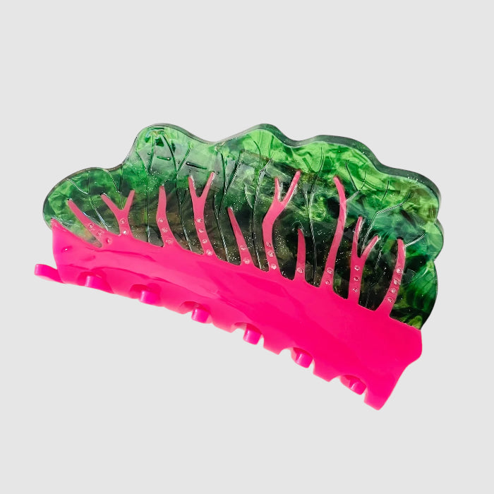 Side view of a 'glowing chard' style hair claw clip on a light grey background.