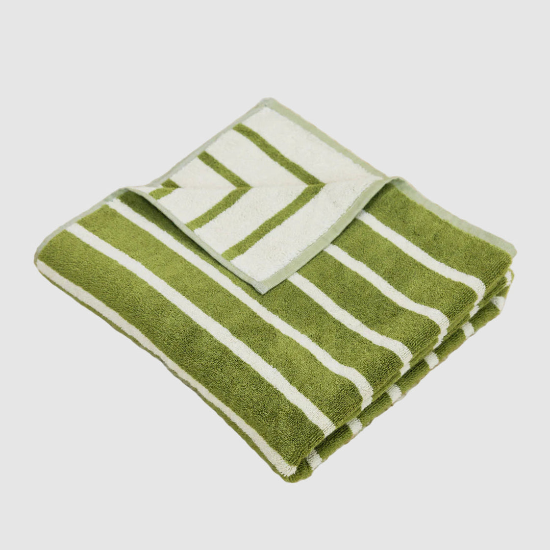 Olive green and beige striped dusen dusen bath towel folded neatly on a light grey background