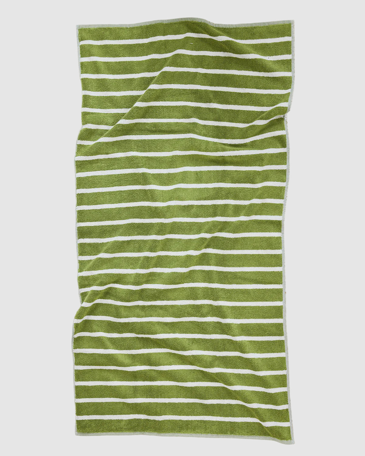 Olive green and beige striped dusen dusen bath towel laying flat on a light grey background