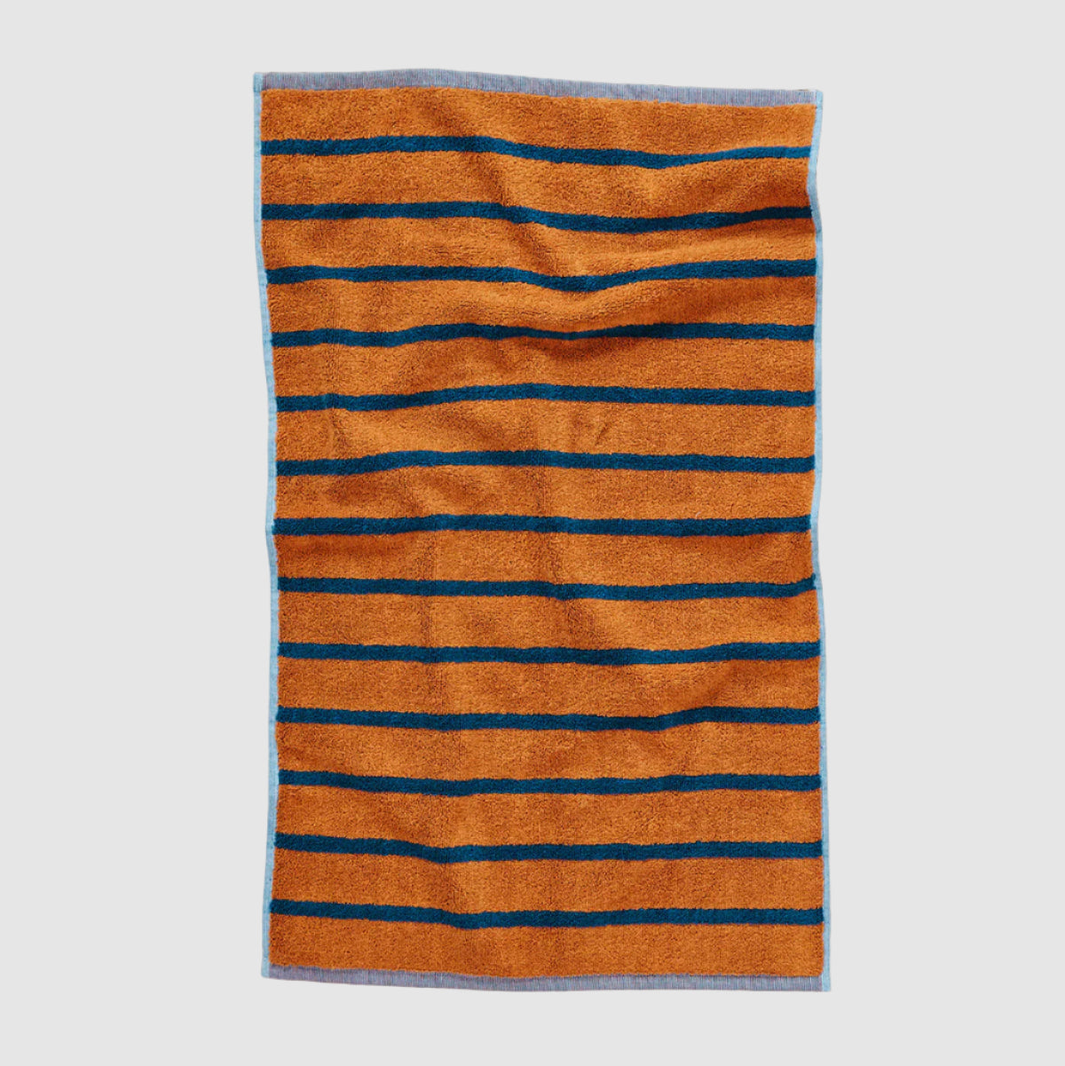 Striped dusen dusen hand towel with orange and blue stripes on a light grey background