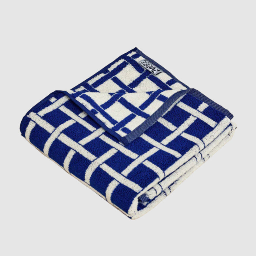 Blue and white checkered towel on a lighrt grey background