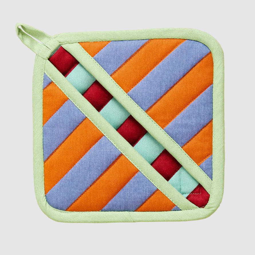 Colorful quilted Dusen Dusen potholder with a striped pattern on a light grey background
