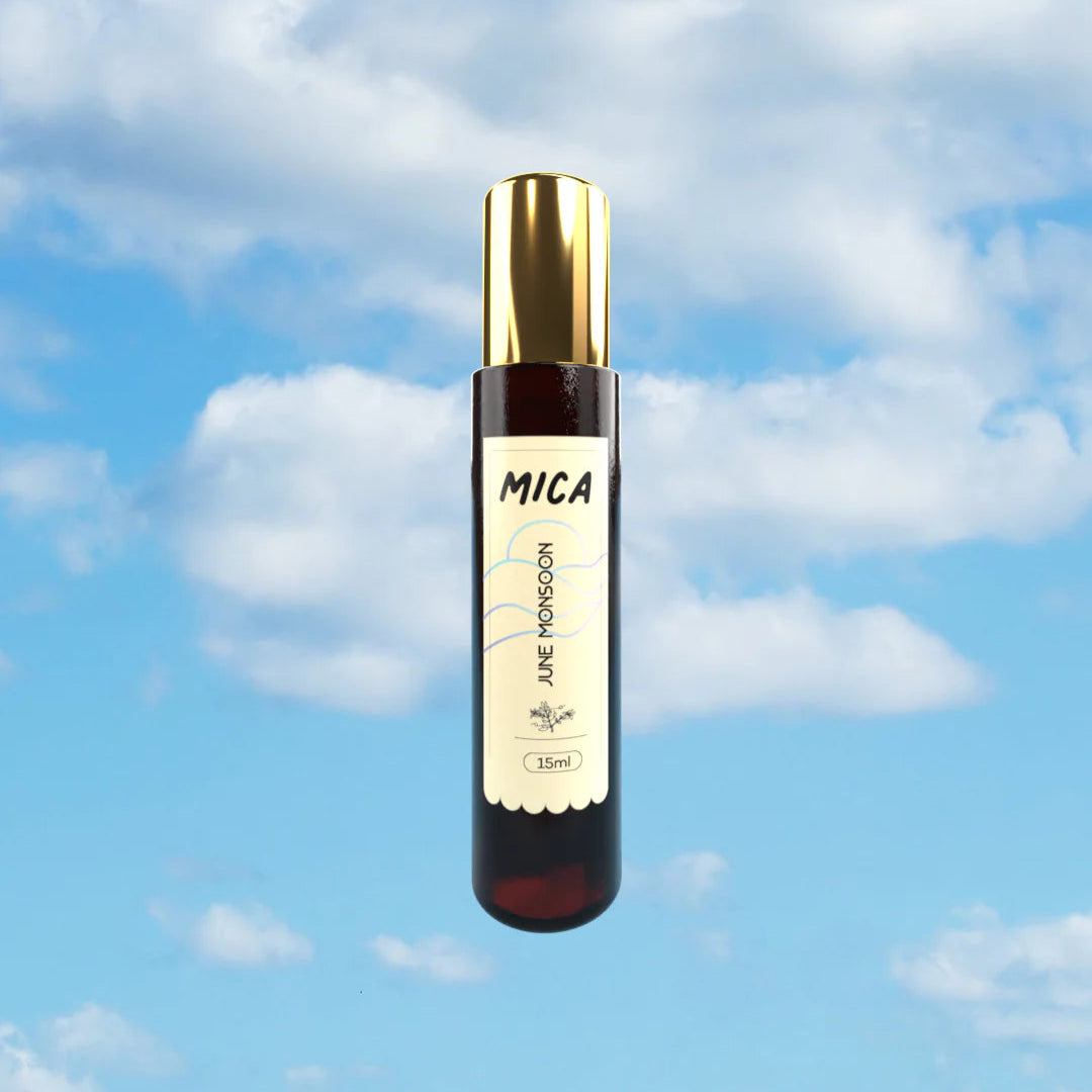Mica perfume bottle with gold cap against a blue sky background