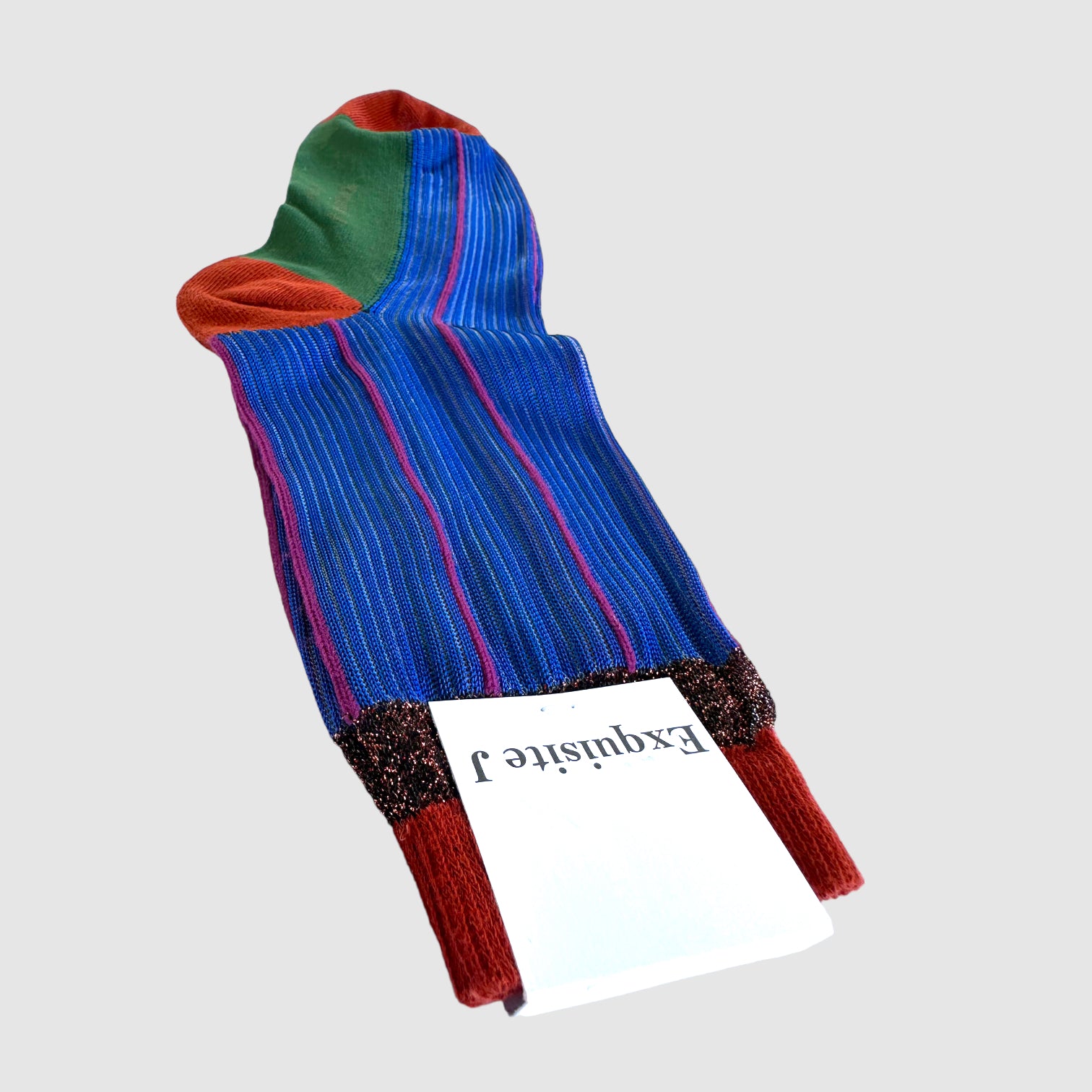 Colorful sock with red, blue, and green on a light gray background