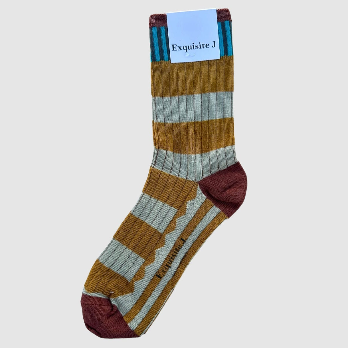 A pair of striped socks with mustard yellow and light grey blue stripes and rust toe and heel, displayed with the brand tag visible.