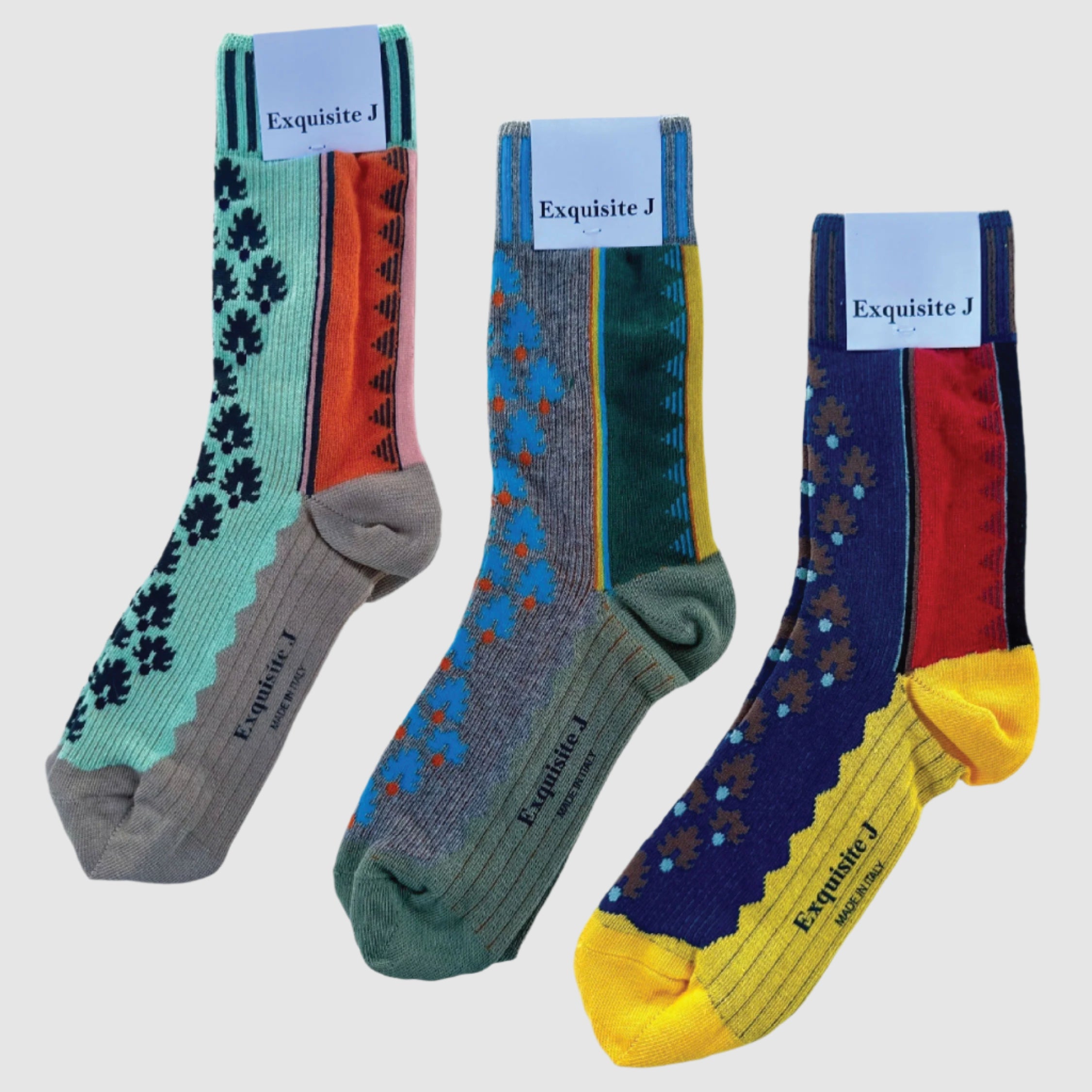 Three pairs of colorful socks with floral patterns on a light gray background, branded 'Exquisite J'.