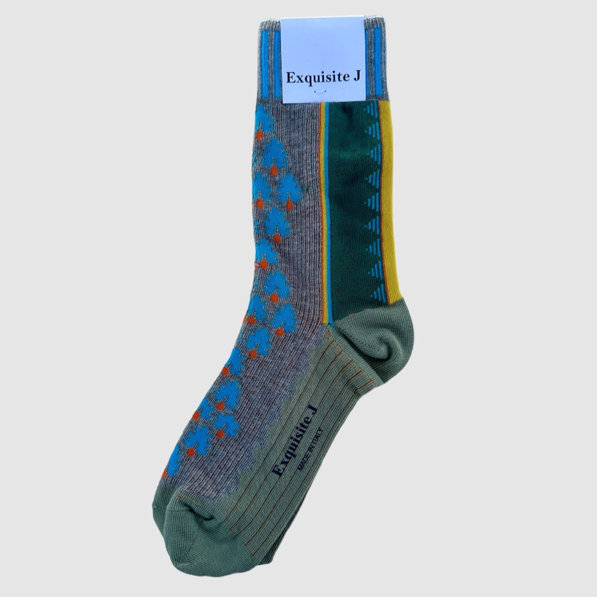 A pair of patterned cotton socks with a combination of gray, blue, green colors and yellow stripes, displayed with the brand label 'Exquisite J' visible.