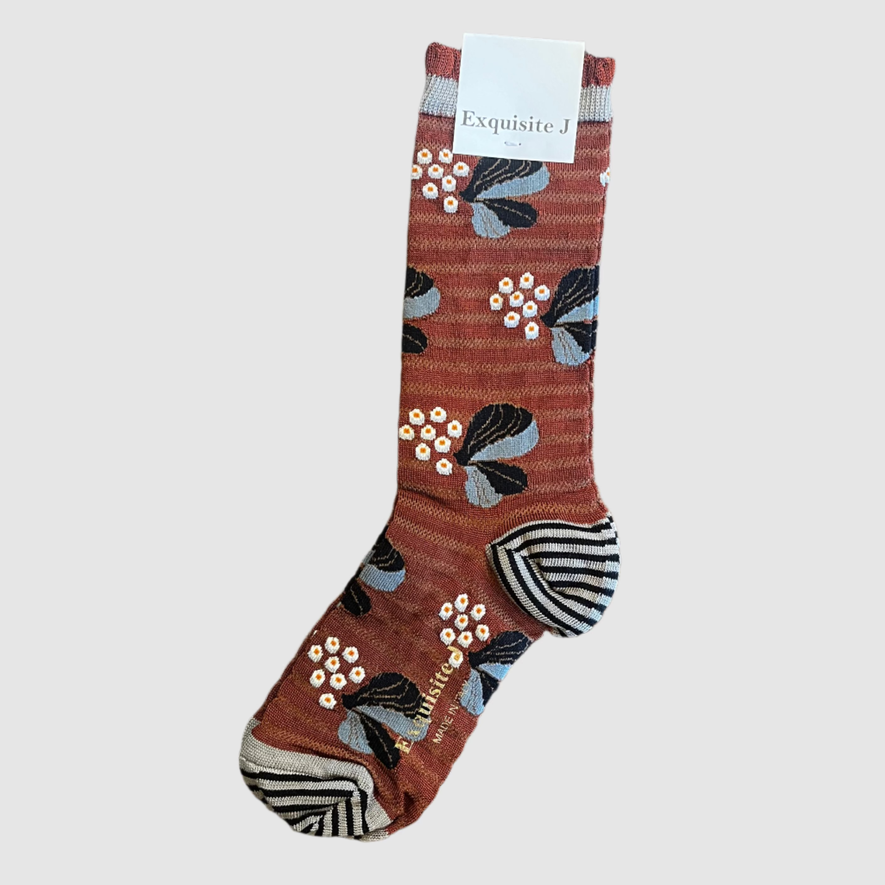 Brown sock with floral pattern on a light grey background