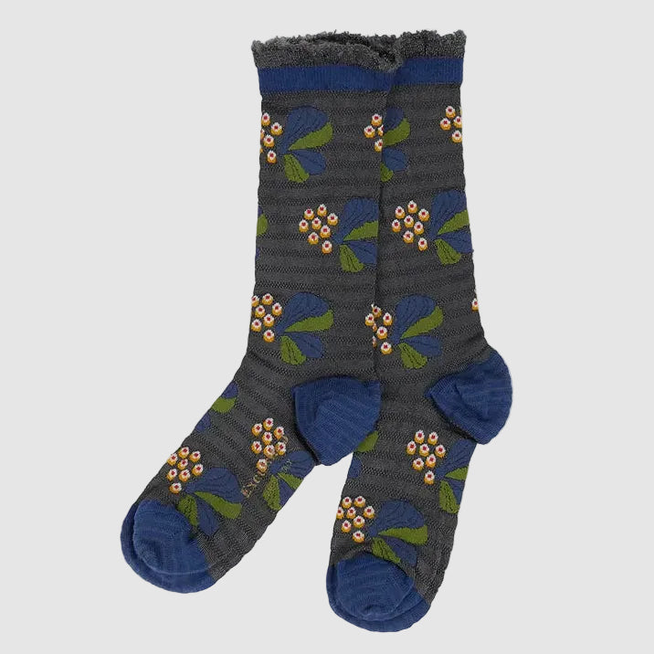 A pair of dark gray ribbed socks with a blue, green, and orange floral pattern, featuring solid blue heels, toes, and cuffs, displayed on a light gray background.