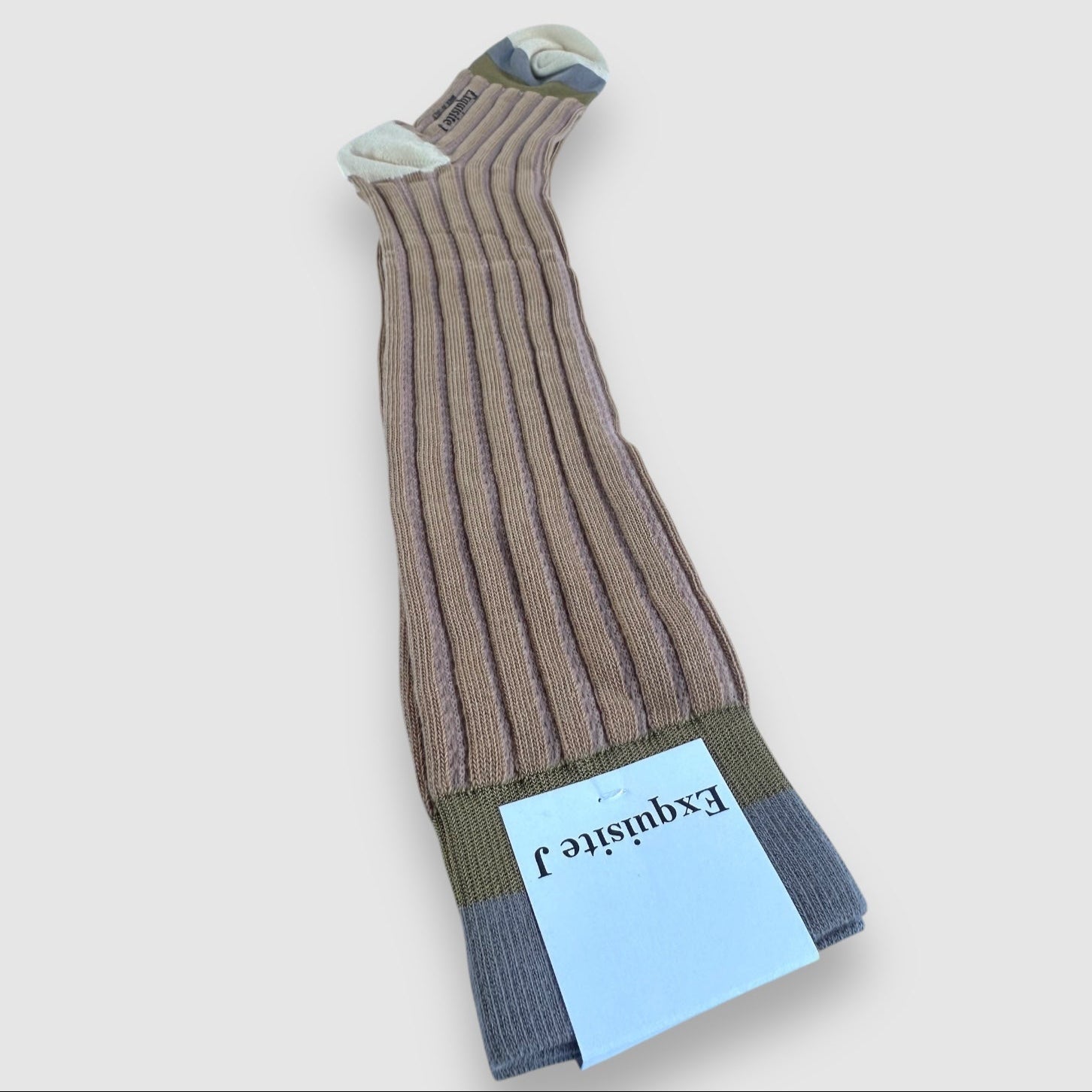 Knee-high socks in a tan color, with a label indicating the brand name 'Exquisite J'. The socks have a striped pattern and a visible brand tag.