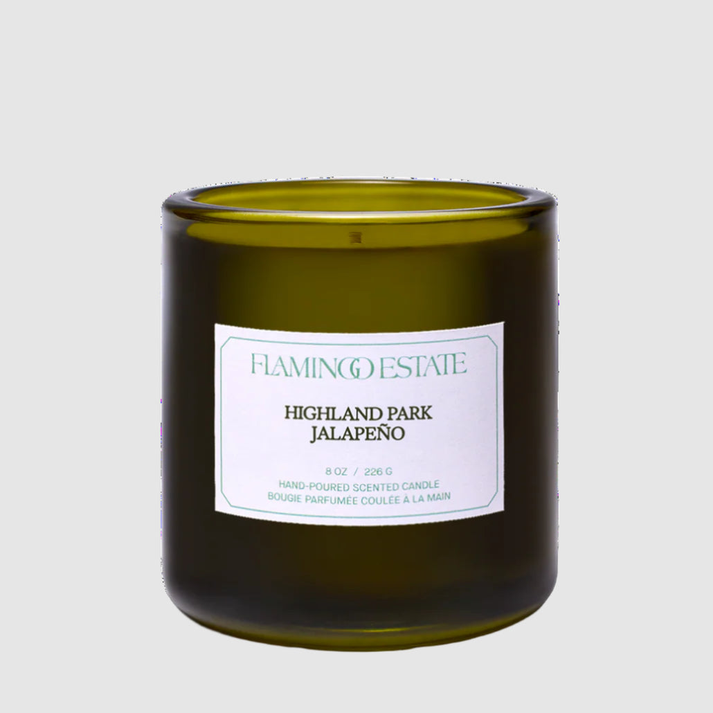 Green Flamingo Estate candle with a label reading "Highland Park Jalapeño" on a white background