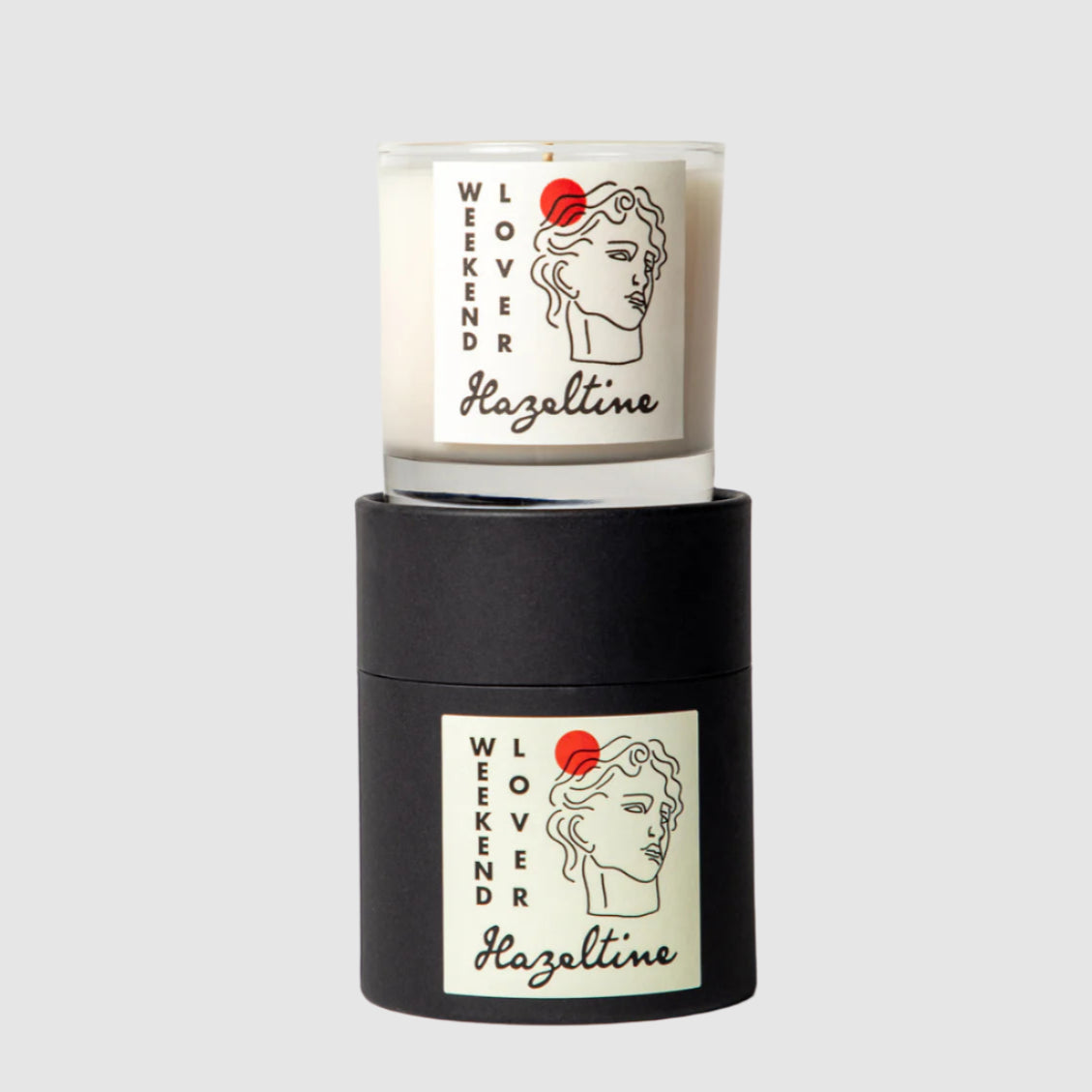 Candle with 'Weekender Hazeltime' branding on a white background