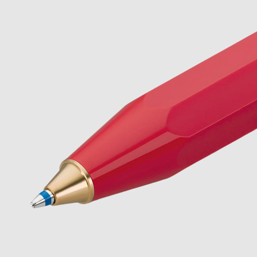 Red pen with a gold cap on a white background