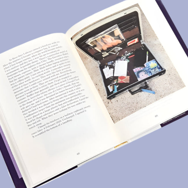 Open book with a wallet containing cards and a phone on a white background
