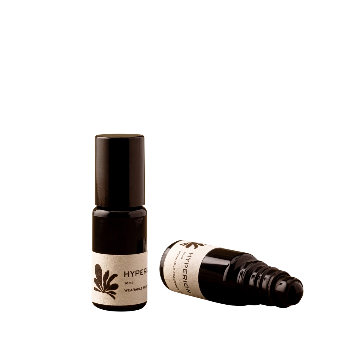 Two small dark amber roll-on bottles with cream labels, one standing upright and one lying on its side, on a plain white background. The upright and sideways bottles labels read "HYPERION".