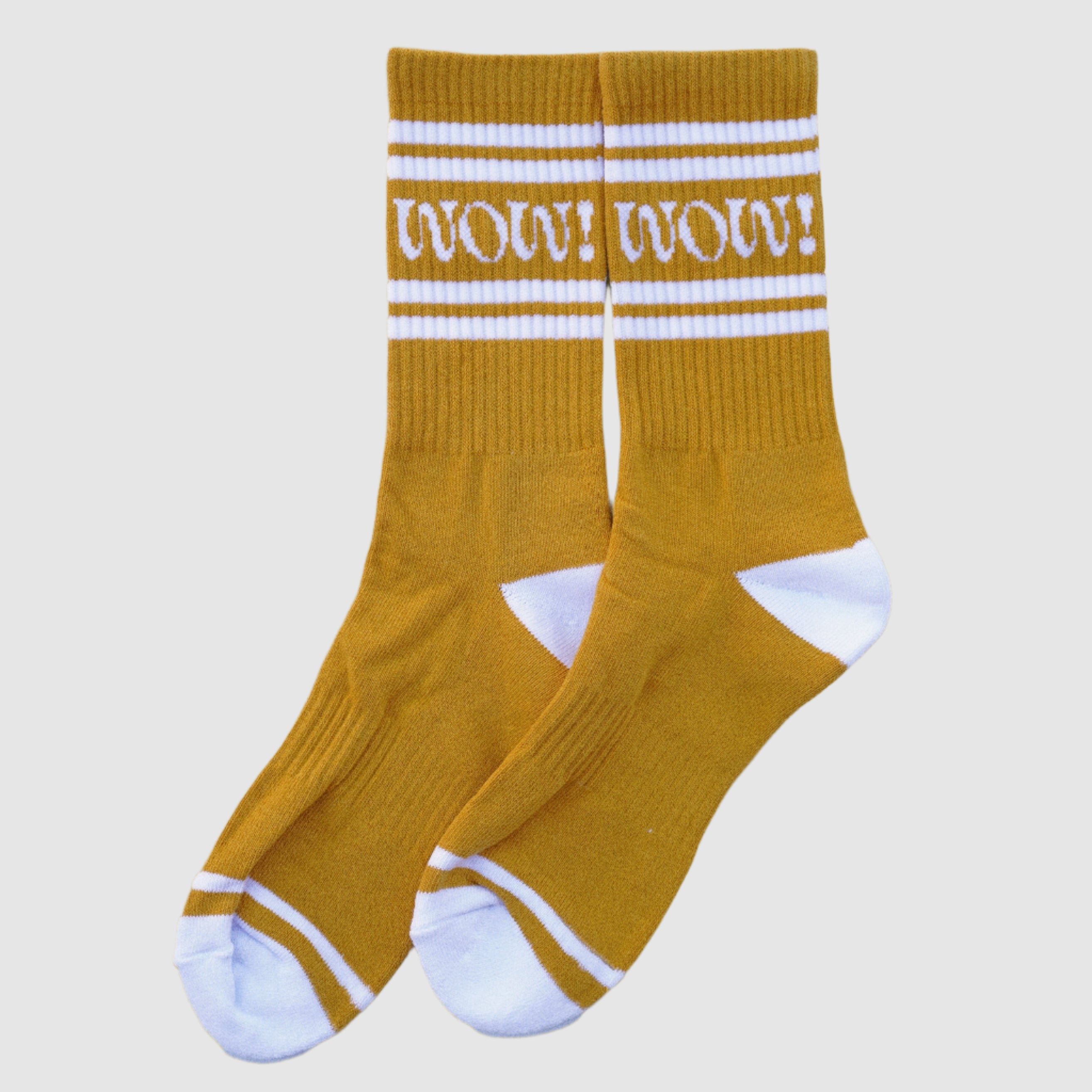 A pair of yellow socks with a white decorative design on the top and white ribbing at the ankle.