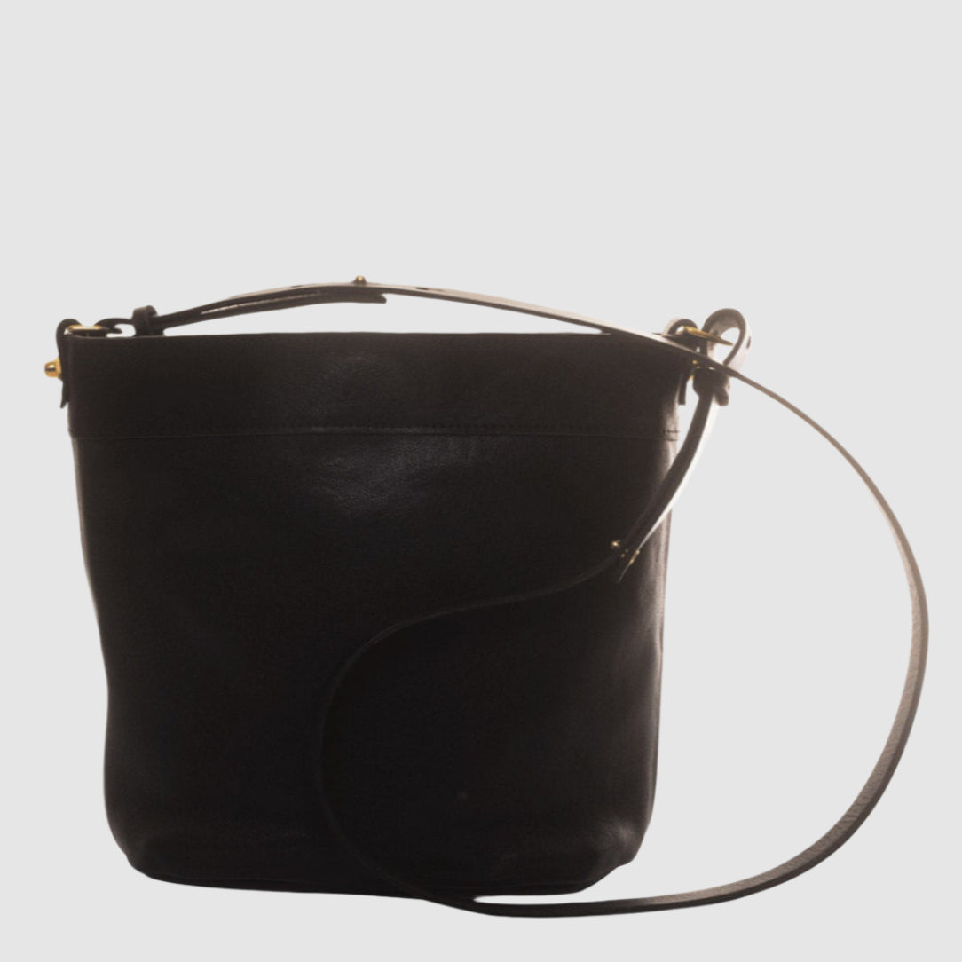 A charcoal gray leather bucket bag with an adjustable leather strap, displayed against a plain background.