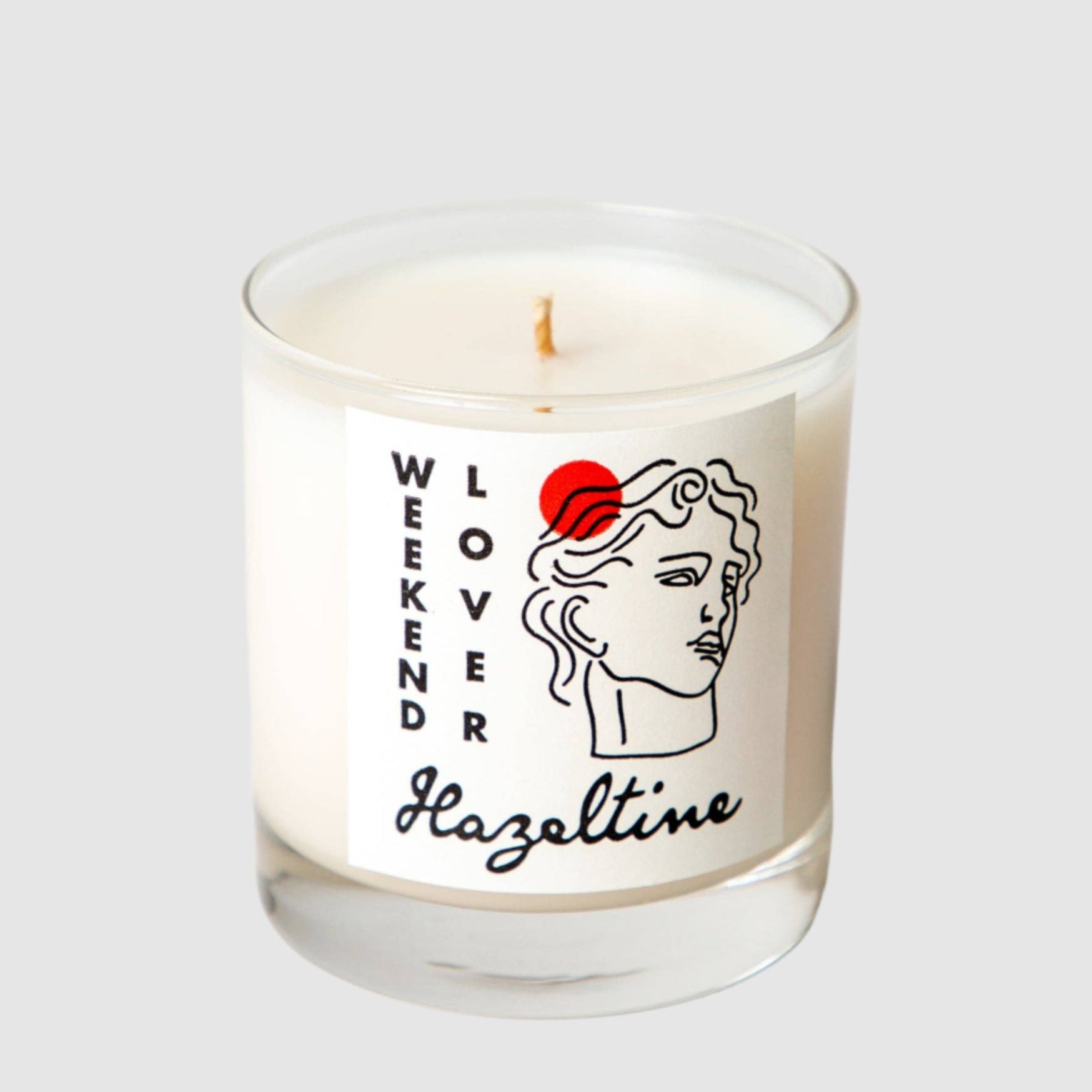 Candle with 'Weekend Lover Hazeltine' label on a white background