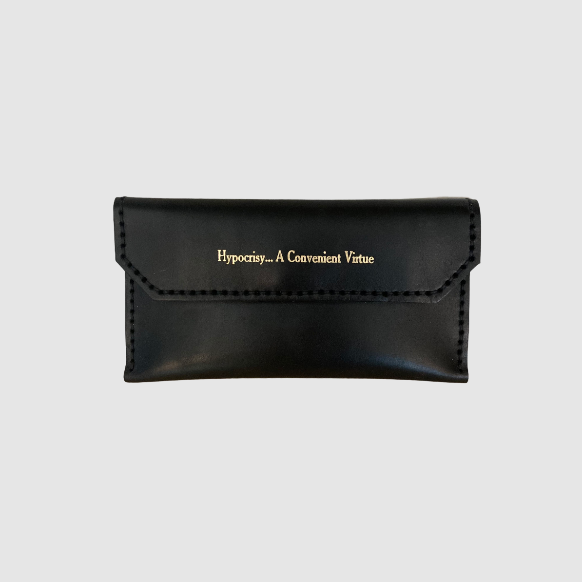 Black leather wallet with 'Hypocrisy, A Convenient Virtue' text and a gold foil sentiment on the front.