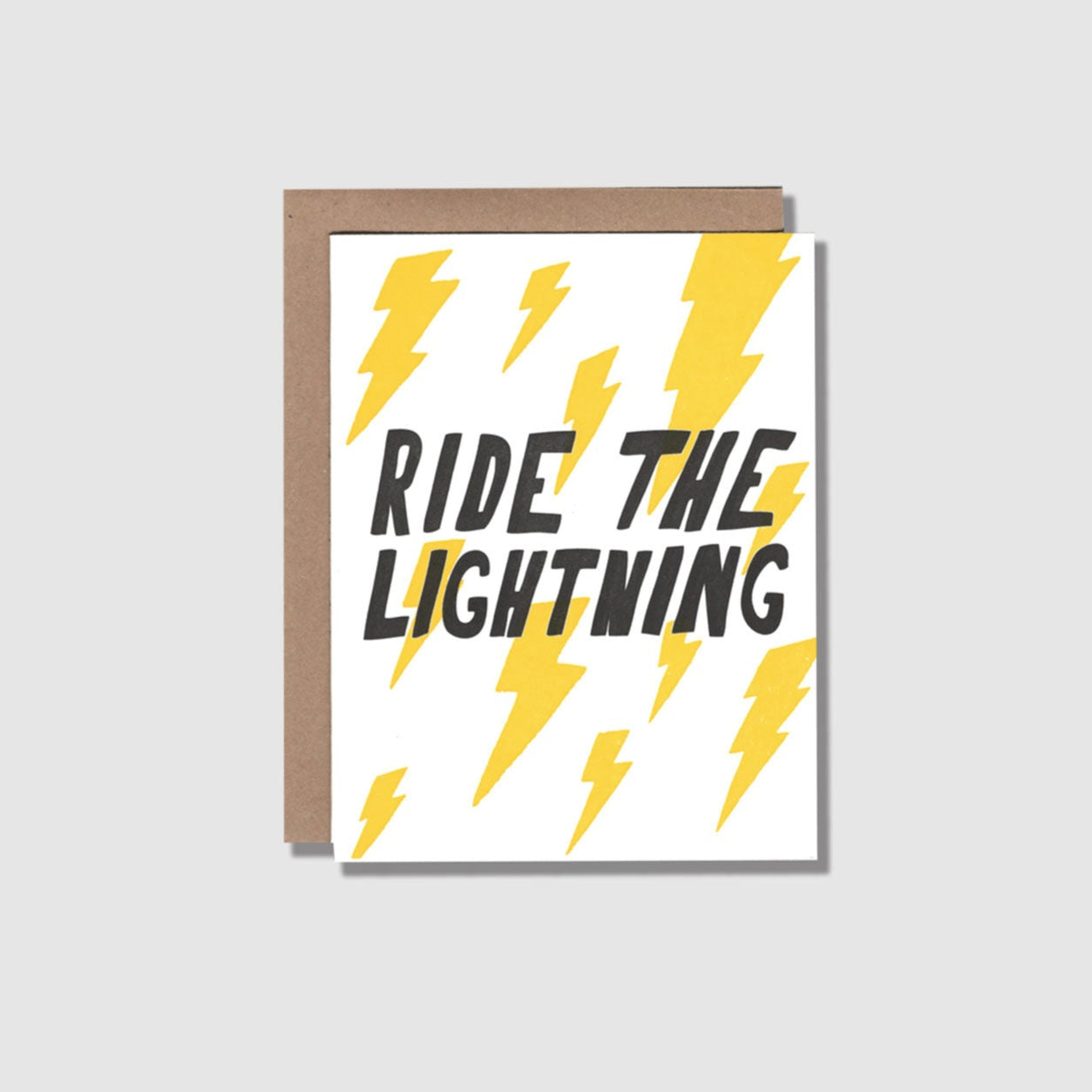 Front view of a greeting card with yellow lightning bolts printed on a white card. "Ride the lightining" is across the center middle.